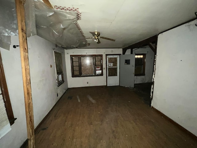 unfurnished room featuring ceiling fan and dark wood-type flooring