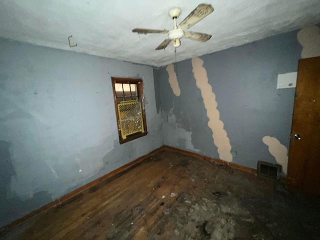 empty room with ceiling fan and wood-type flooring