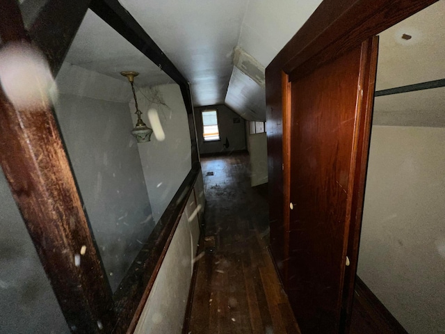 hall with dark hardwood / wood-style floors and vaulted ceiling