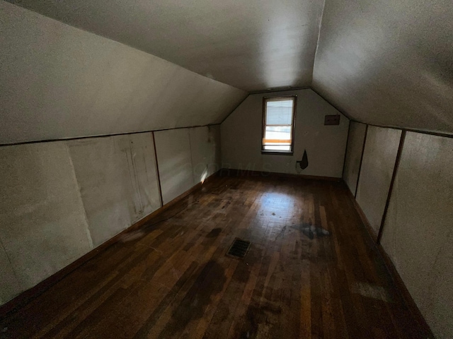 bonus room featuring dark hardwood / wood-style floors and lofted ceiling