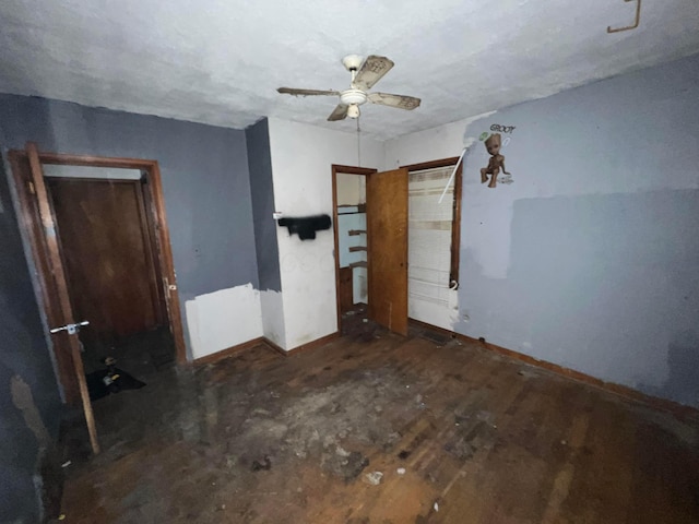 unfurnished bedroom featuring ceiling fan and dark hardwood / wood-style flooring