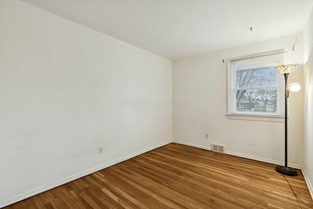 empty room with wood-type flooring