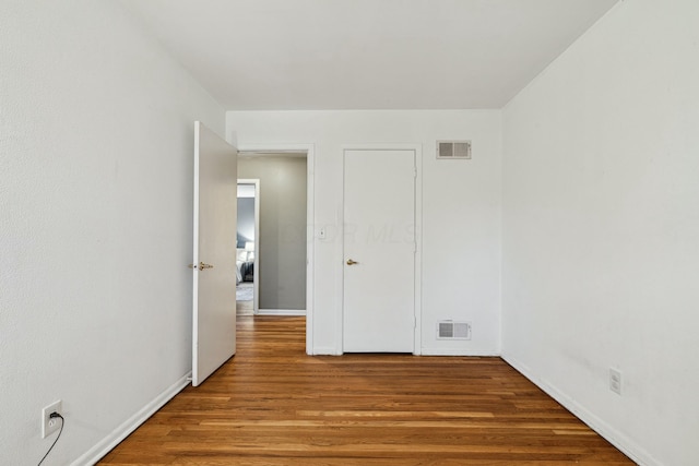 unfurnished room featuring wood-type flooring