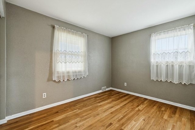 spare room with wood-type flooring