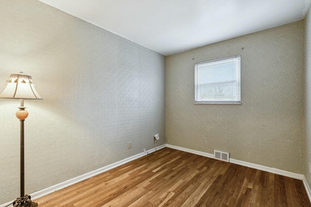 empty room with hardwood / wood-style floors