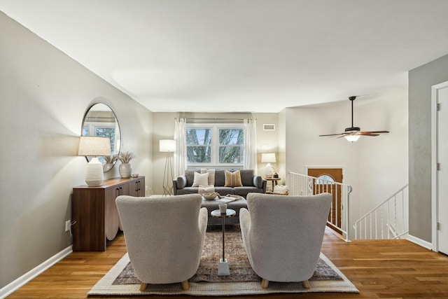 living room with hardwood / wood-style floors and ceiling fan