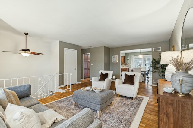 living room featuring hardwood / wood-style flooring and ceiling fan