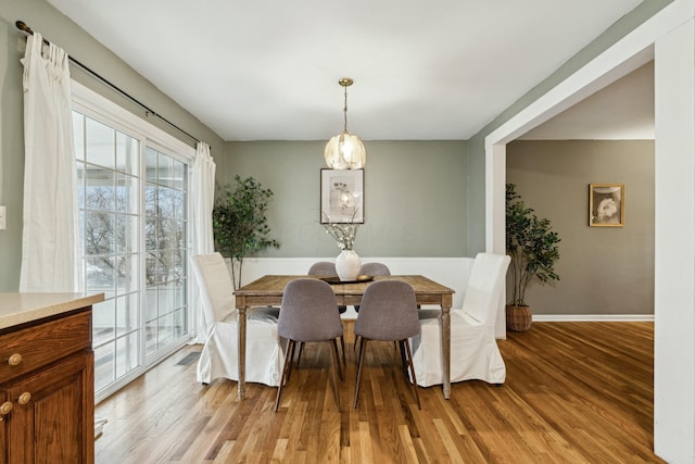 dining space with light hardwood / wood-style flooring