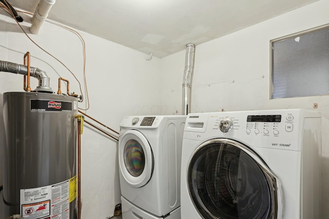 clothes washing area with washer and dryer and gas water heater