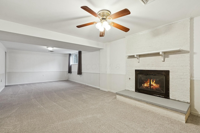 unfurnished living room featuring ceiling fan, a fireplace, and carpet