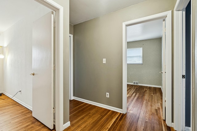 hall with wood-type flooring