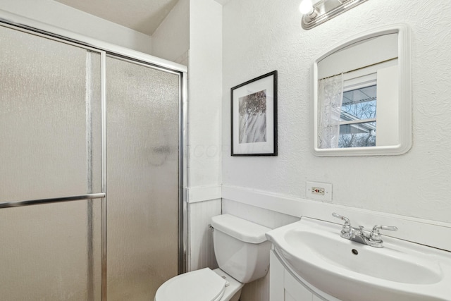 bathroom featuring vanity, toilet, and walk in shower