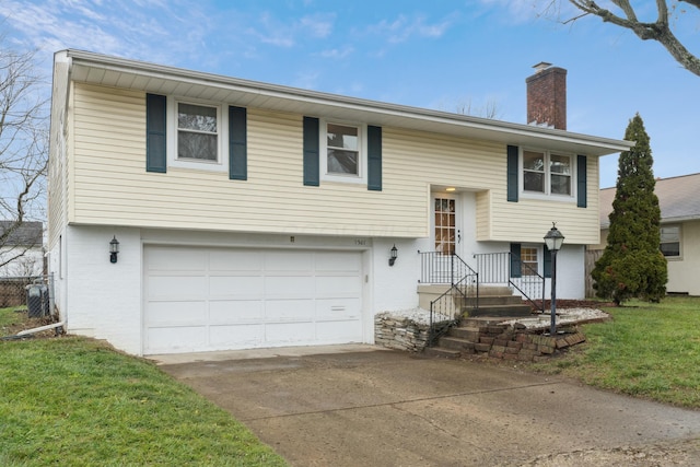 split foyer home featuring a garage and a front lawn