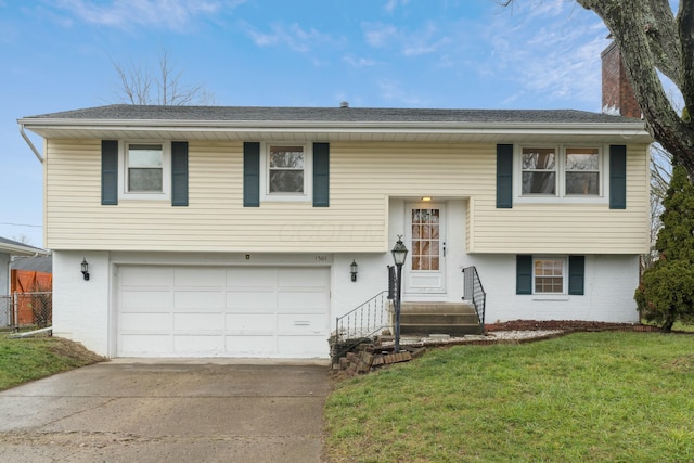 split foyer home with a front yard and a garage