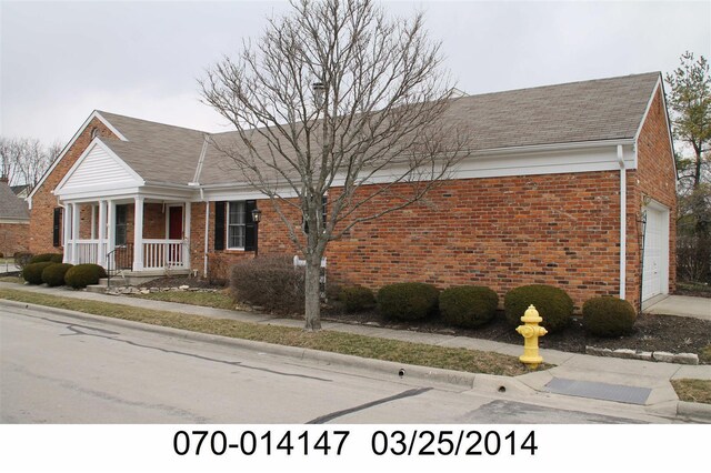 view of front of property featuring a garage and brick siding