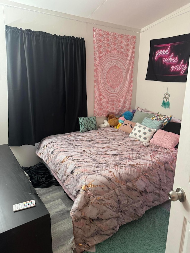 bedroom with hardwood / wood-style flooring and crown molding