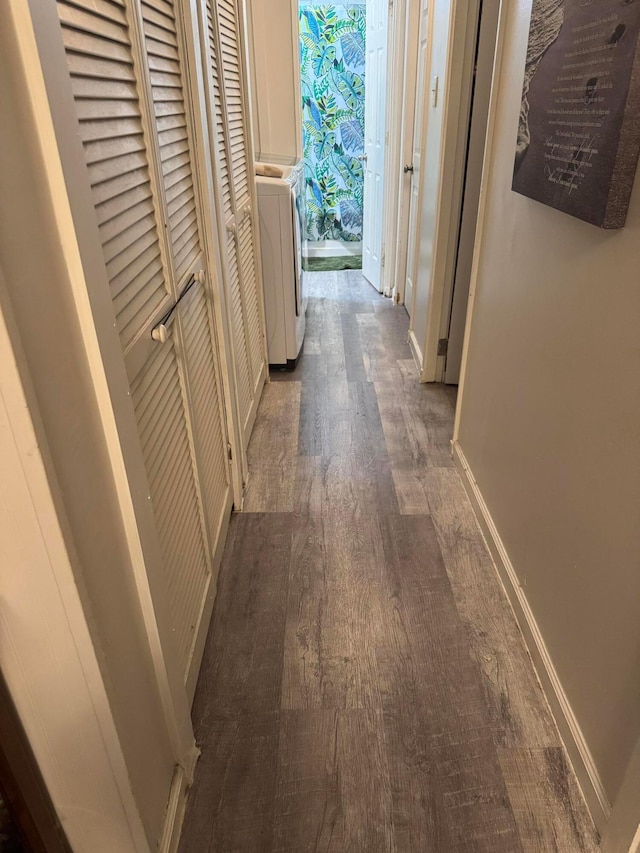 hallway with washer / clothes dryer and dark hardwood / wood-style floors