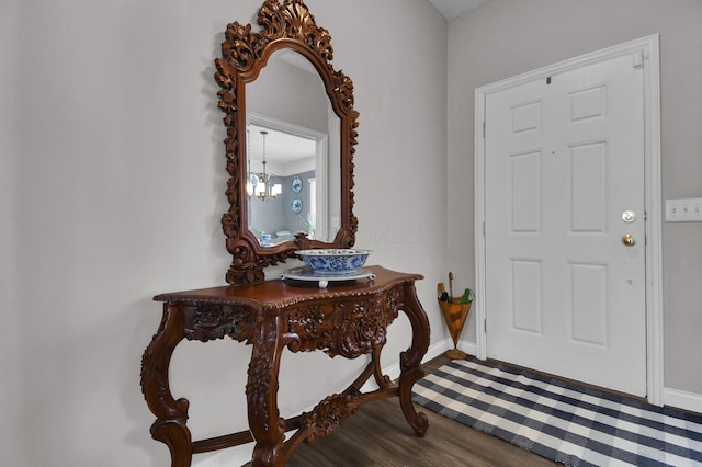 entryway featuring hardwood / wood-style flooring and a chandelier