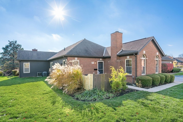 view of side of home featuring a lawn