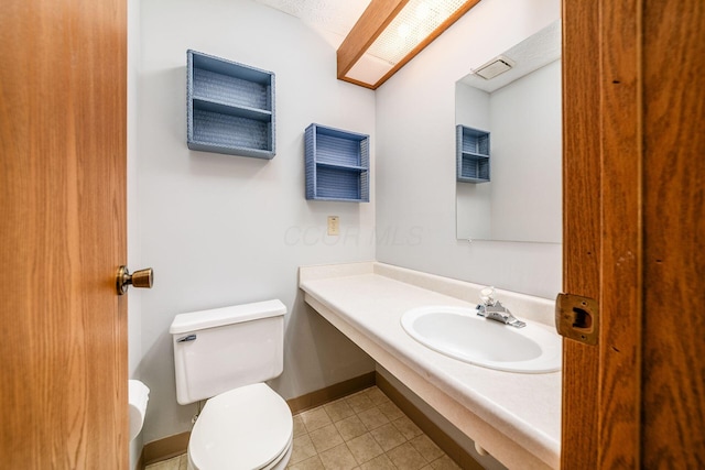 bathroom with tile patterned flooring, toilet, and sink