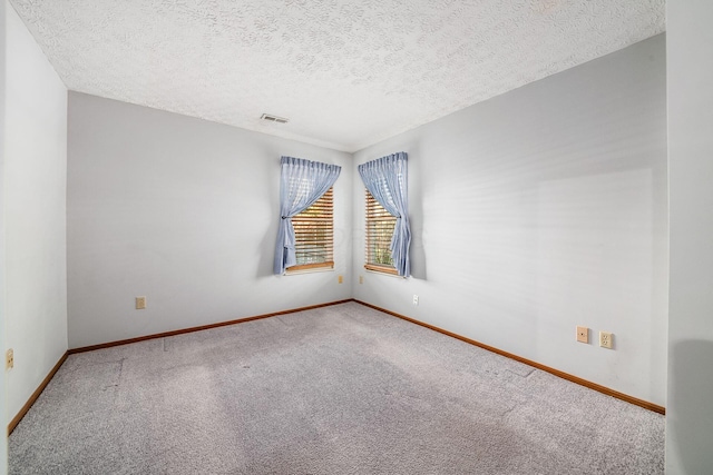 unfurnished room featuring carpet floors and a textured ceiling