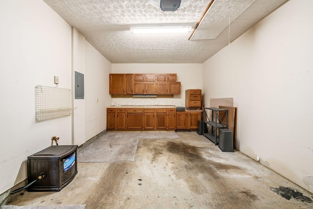 kitchen with a textured ceiling and electric panel