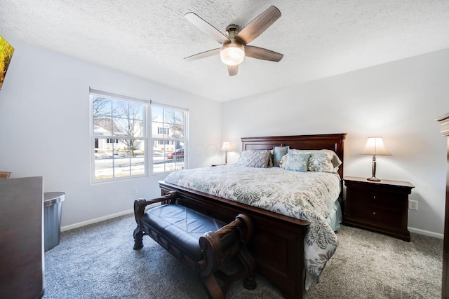 carpeted bedroom featuring ceiling fan and a textured ceiling