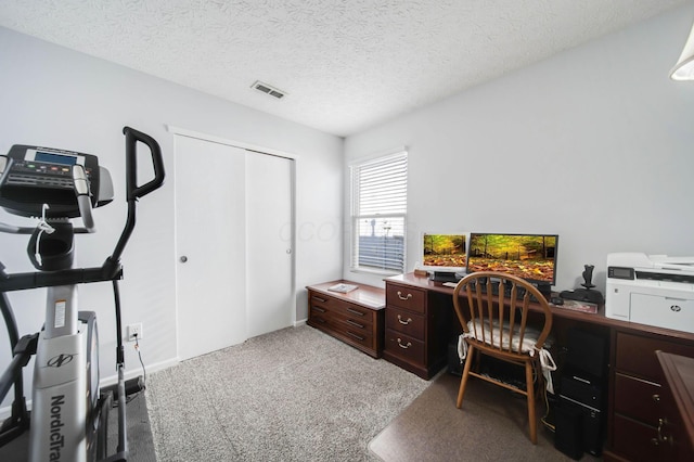 office area with carpet floors and a textured ceiling