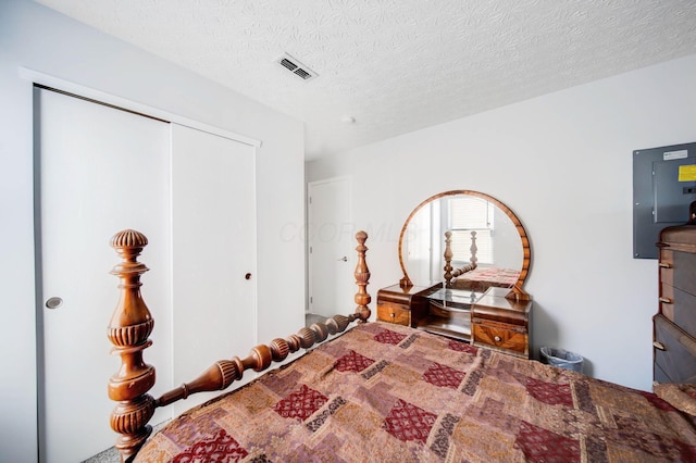 bedroom with a closet and a textured ceiling