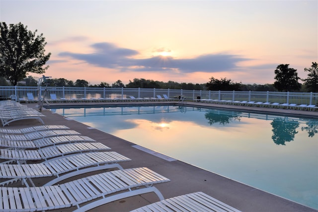 view of pool at dusk