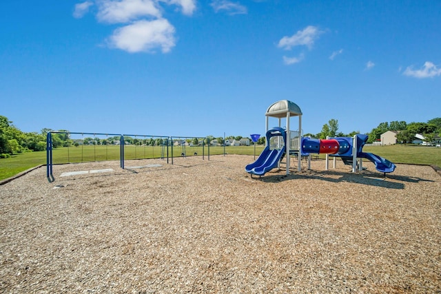 view of jungle gym featuring a lawn