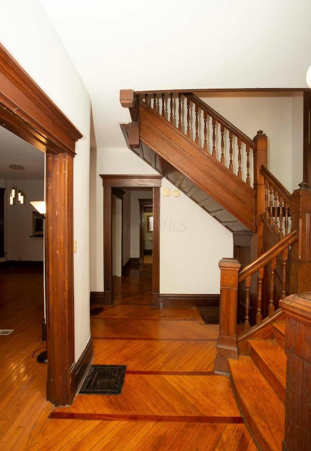 stairway with hardwood / wood-style floors