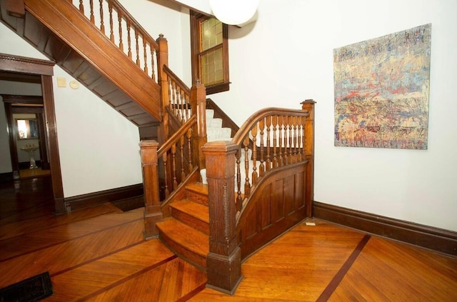 staircase featuring wood-type flooring