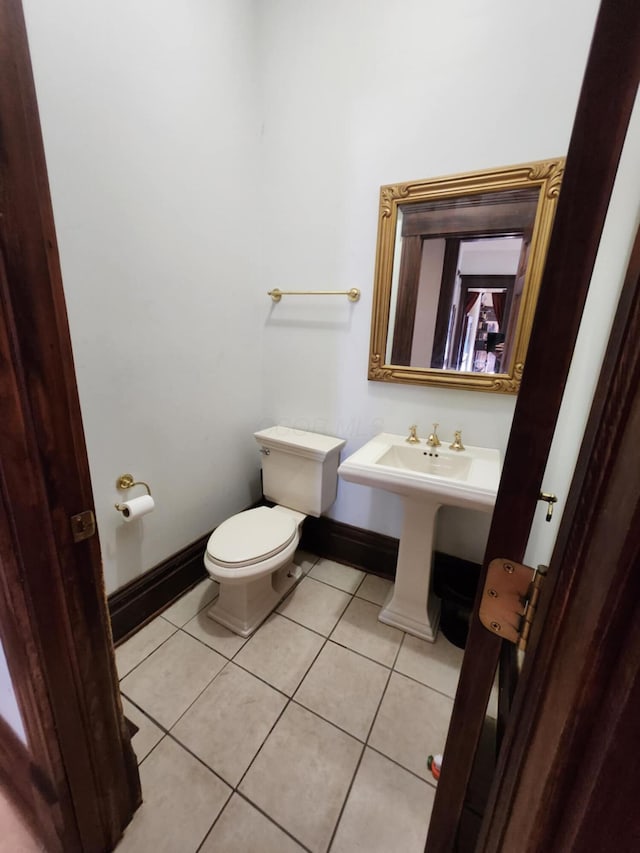 bathroom featuring tile patterned flooring and toilet