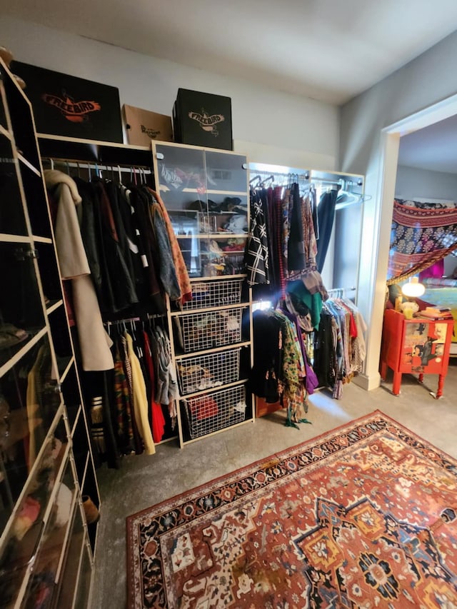 walk in closet featuring carpet flooring