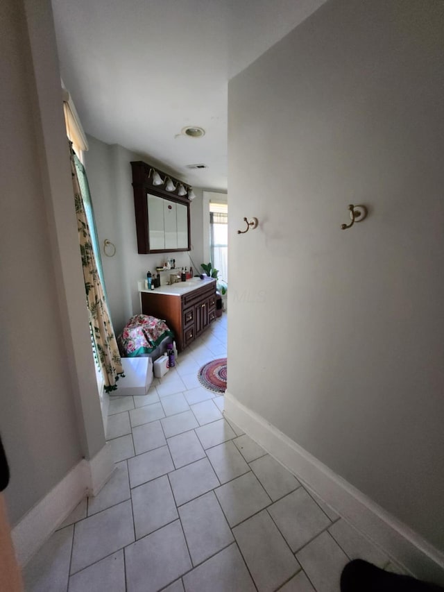 hallway featuring light tile patterned floors