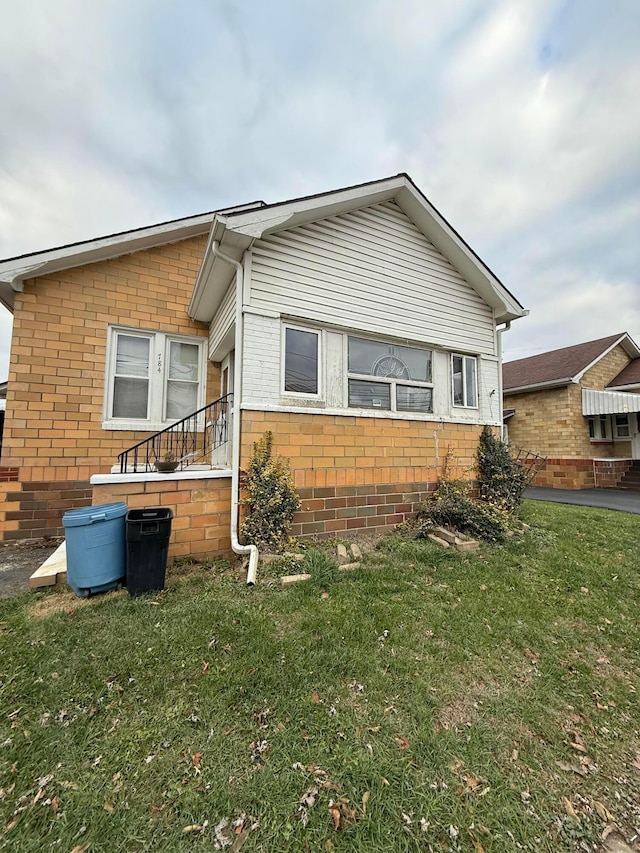 view of home's exterior with a yard