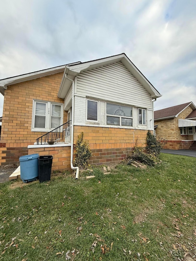 784 E Front St, Logan, OH 43138 - view of side of home featuring a yard and brick siding
