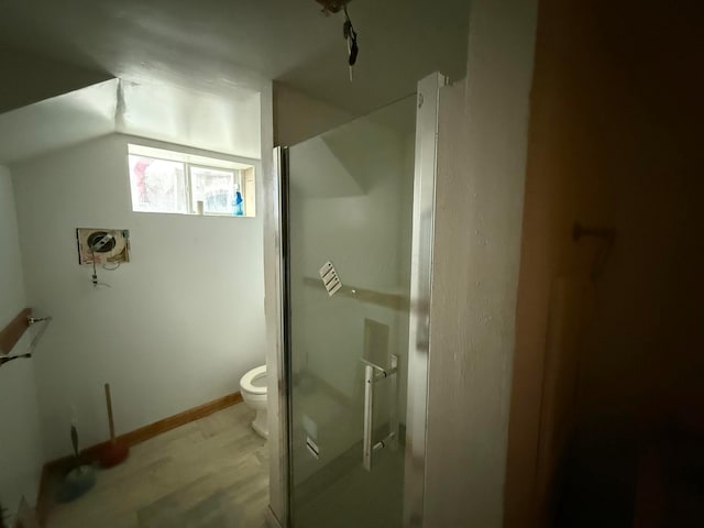 784 E Front St, Logan, OH 43138 - full bath featuring a shower stall, vaulted ceiling, and wood finished floors
