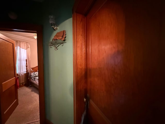 corridor with light carpet and ornamental molding