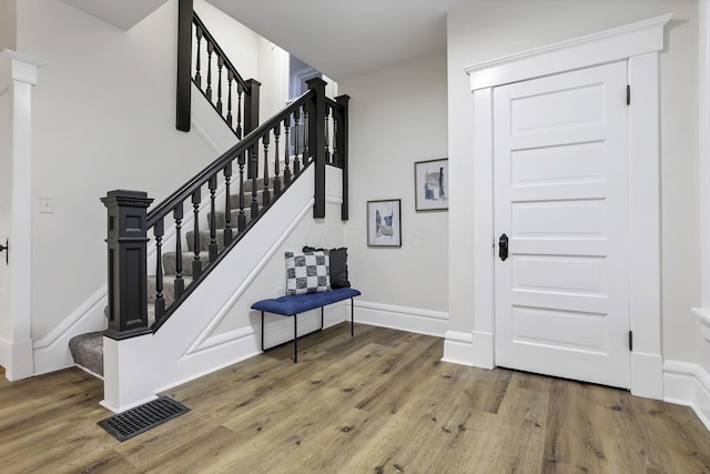 staircase with wood-type flooring