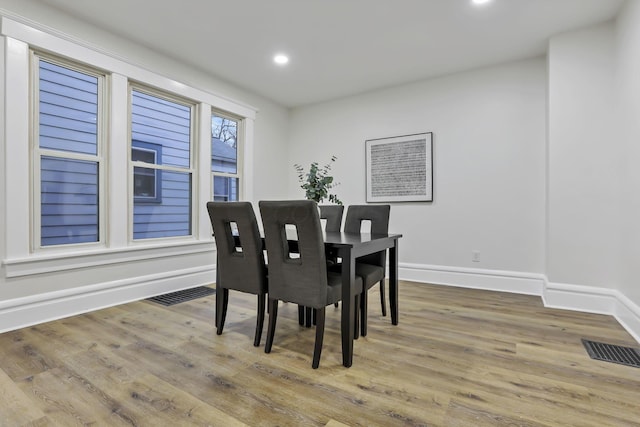 dining area with hardwood / wood-style floors