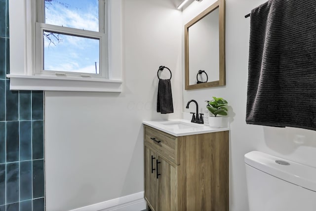 bathroom featuring vanity and toilet