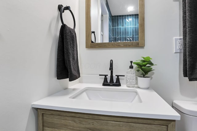 bathroom featuring vanity and toilet