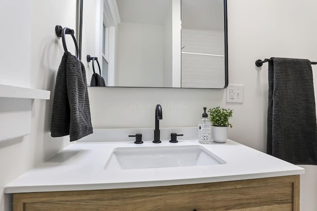 bathroom featuring a shower and vanity