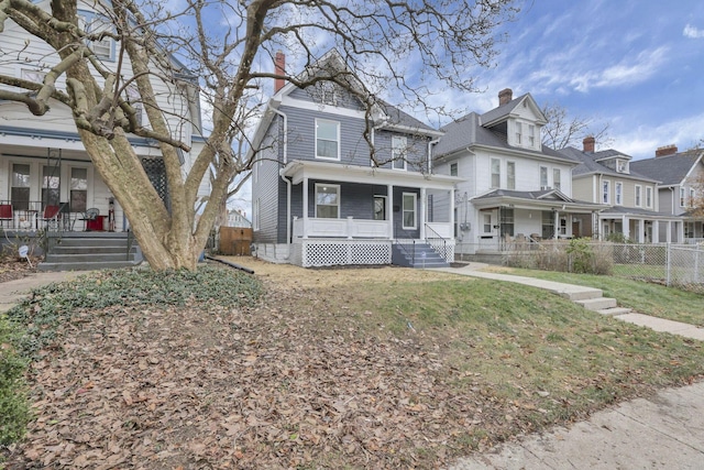 view of front of home featuring a porch and a front lawn