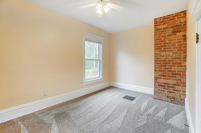 carpeted empty room featuring ceiling fan