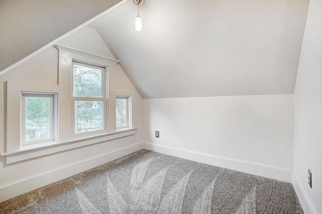 bonus room with carpet flooring and lofted ceiling