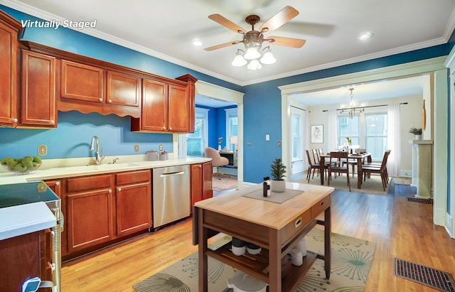 kitchen featuring pendant lighting, crown molding, dishwasher, and light hardwood / wood-style floors