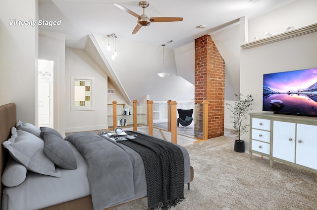 carpeted bedroom with ceiling fan and vaulted ceiling